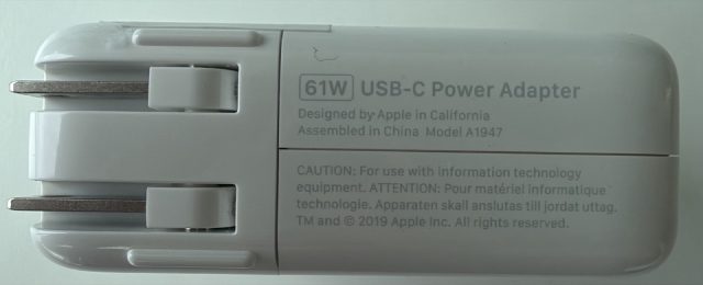 61W USB-C Power Adapter. Designed by Apple in California, Assembled in China. Model A1947. TM and copyright 2019 Apple Inc.