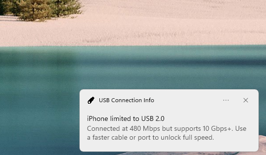 A Windows notification from USB Connection Info: iPhone limited to USB 2.0, connected at 480 Mbps but supports 10 Gbps+